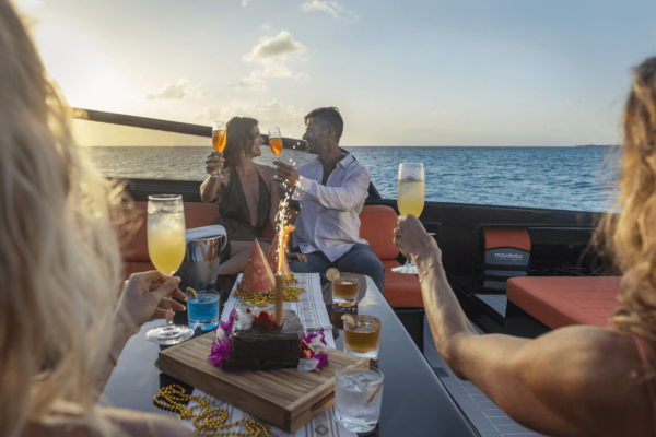 group drinks champagne on yacht at sunset